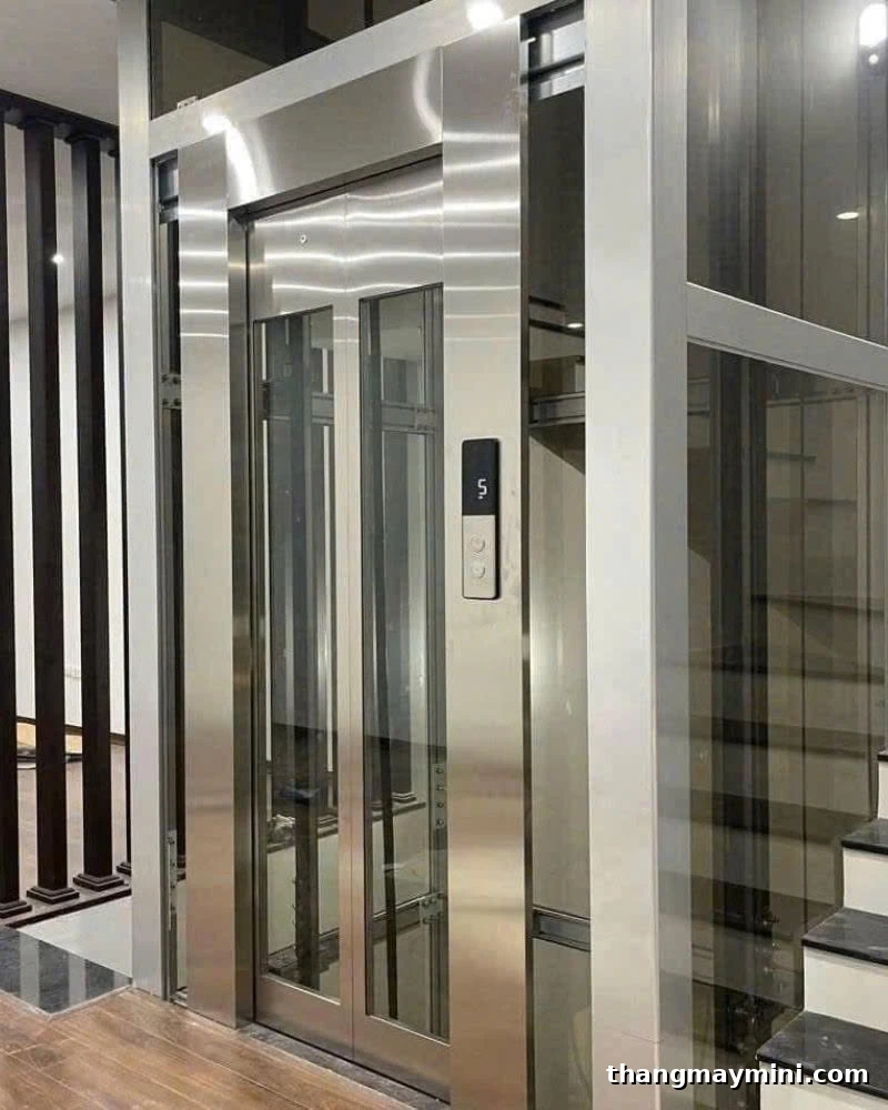 Cabin kính kết hợp inox Cabin thang máy kính kết hợp khung inox cửa lồng kính hoàn thiện trong nhà phố